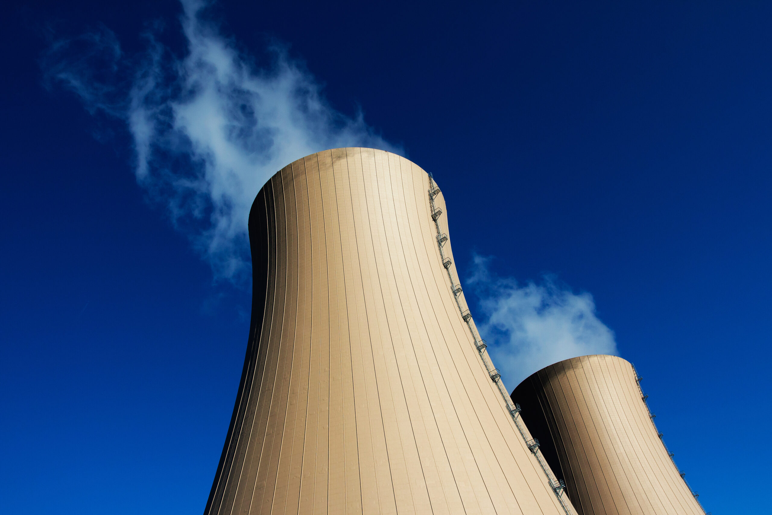 Cooling towers of nuclear power plant against the blue sky